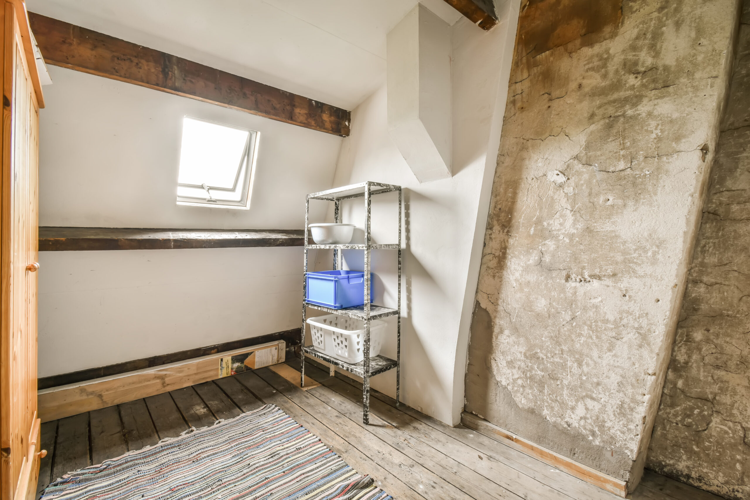 a small room with a wooden floor and a shelf